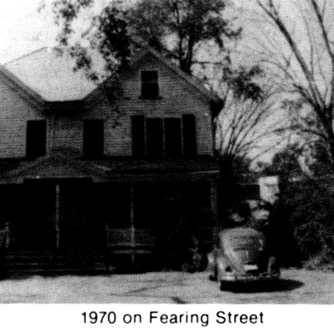 A black and white photo of an old house.